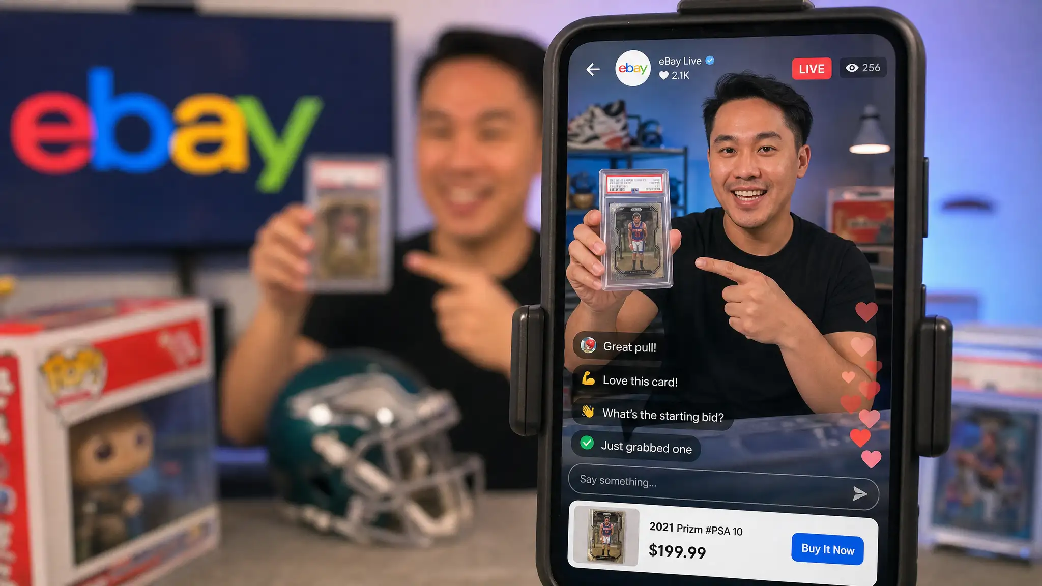 A smartphone displays an eBay Live host presenting a graded basketball card, with viewer comments, floating hearts, and a $199.99 purchase option.